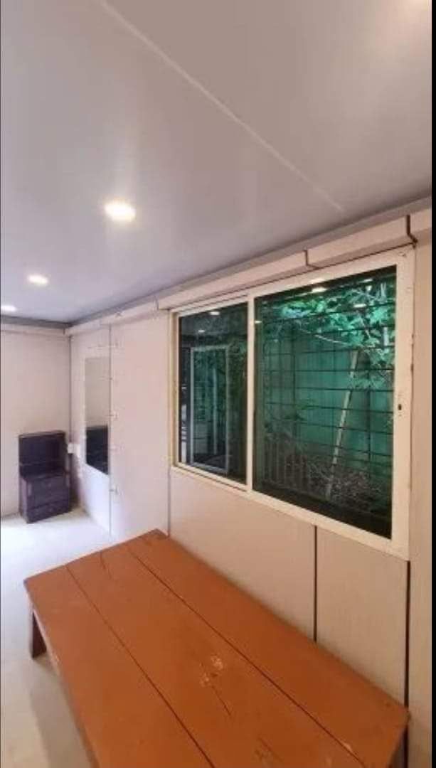 Insulated room with sliding window, mirror unit and bench