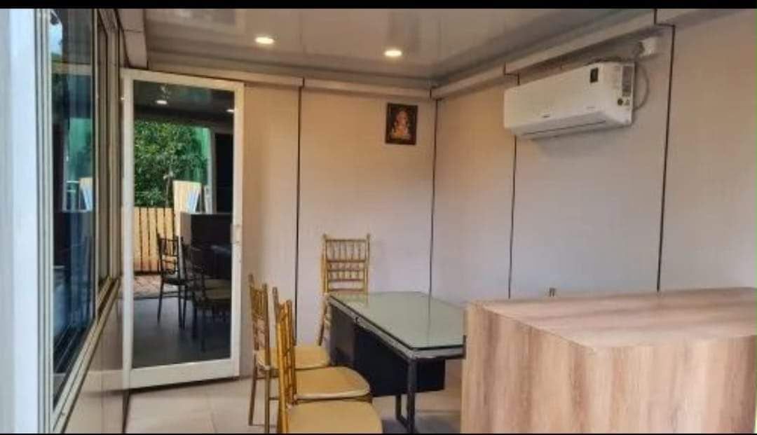 Air-conditioned dining room with recessed lights and glass door