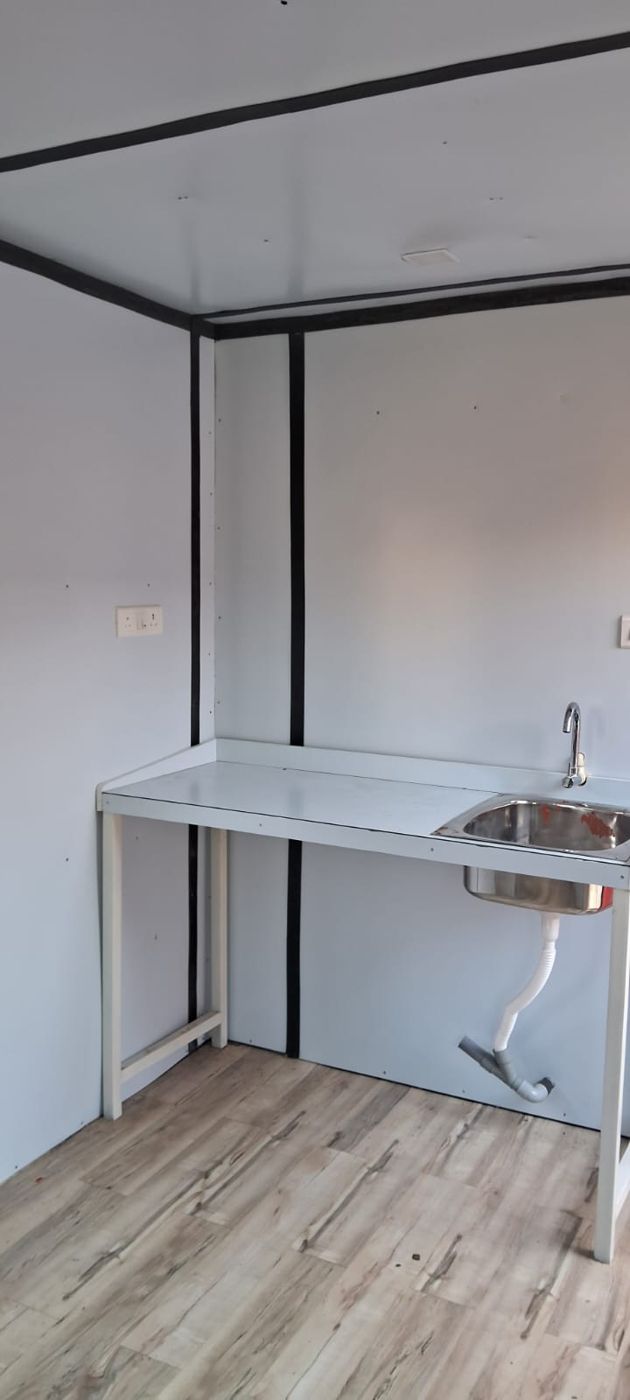 Pantry counter with steel sink and wood-finish flooring