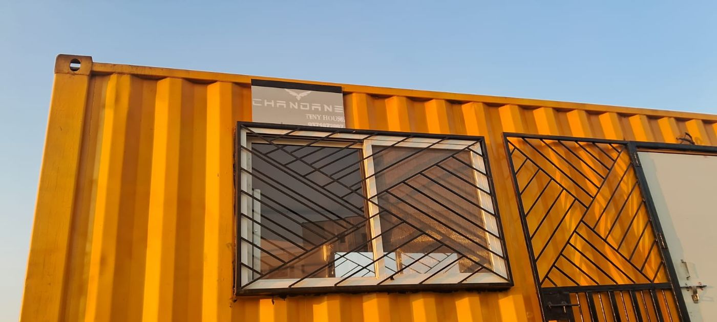 Yellow container with diagonal-grill window and door